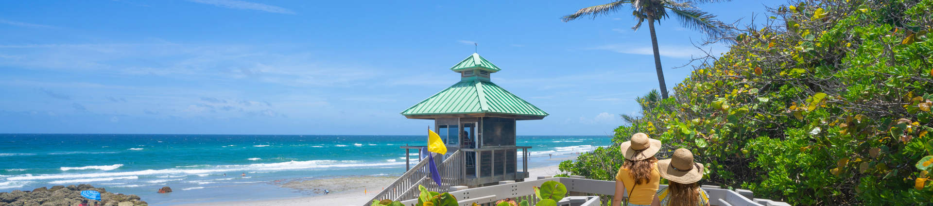 Women Walking On Boardwalk To Florida Beach