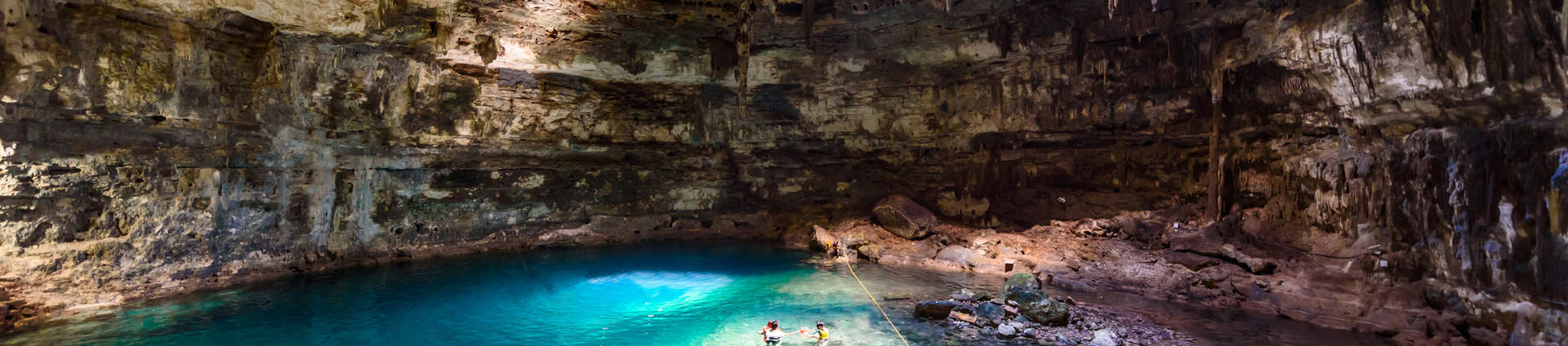Tourists Swimming In Cenote Mexico