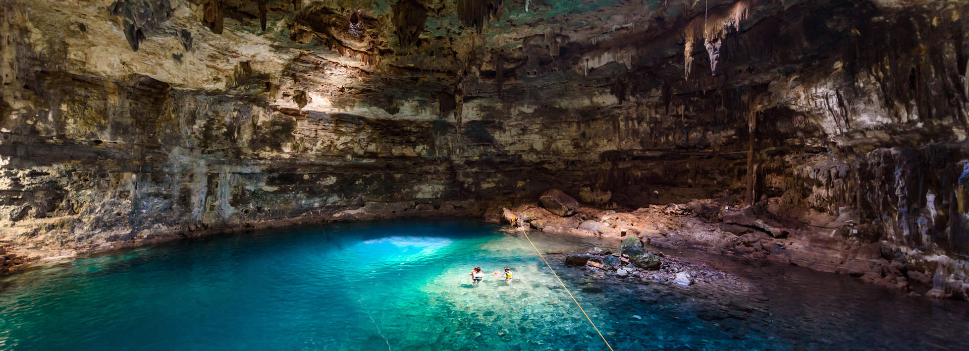 Tourists Swimming In Cenote Mexico