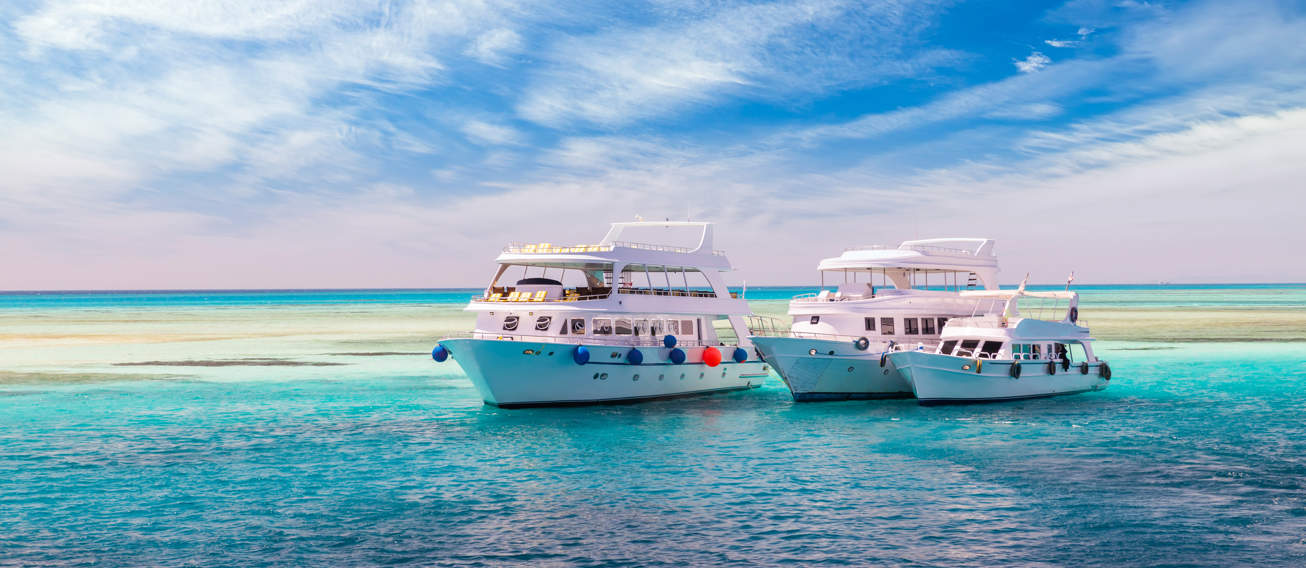 Cruise Yacht Bow In Clear Water Near A Coral Reef. Red Sea, Egypt